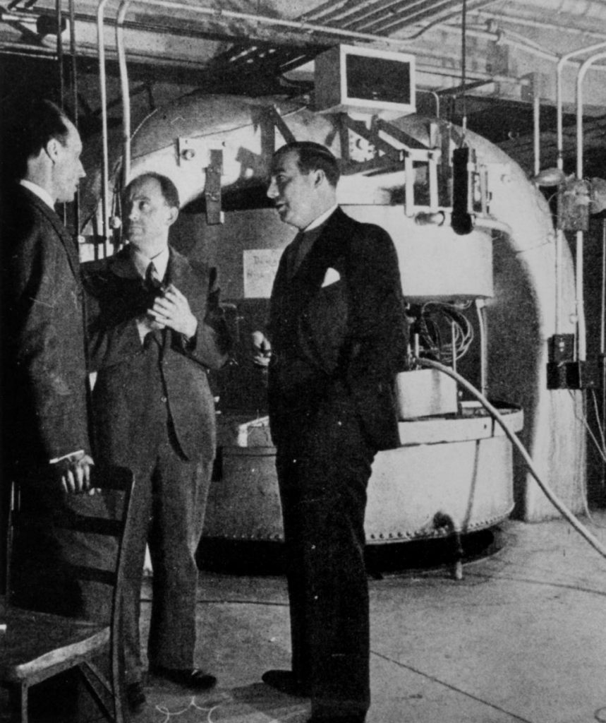 Fermi, Dunning, and Mitchell converse in front of the Columbia Cyclotron